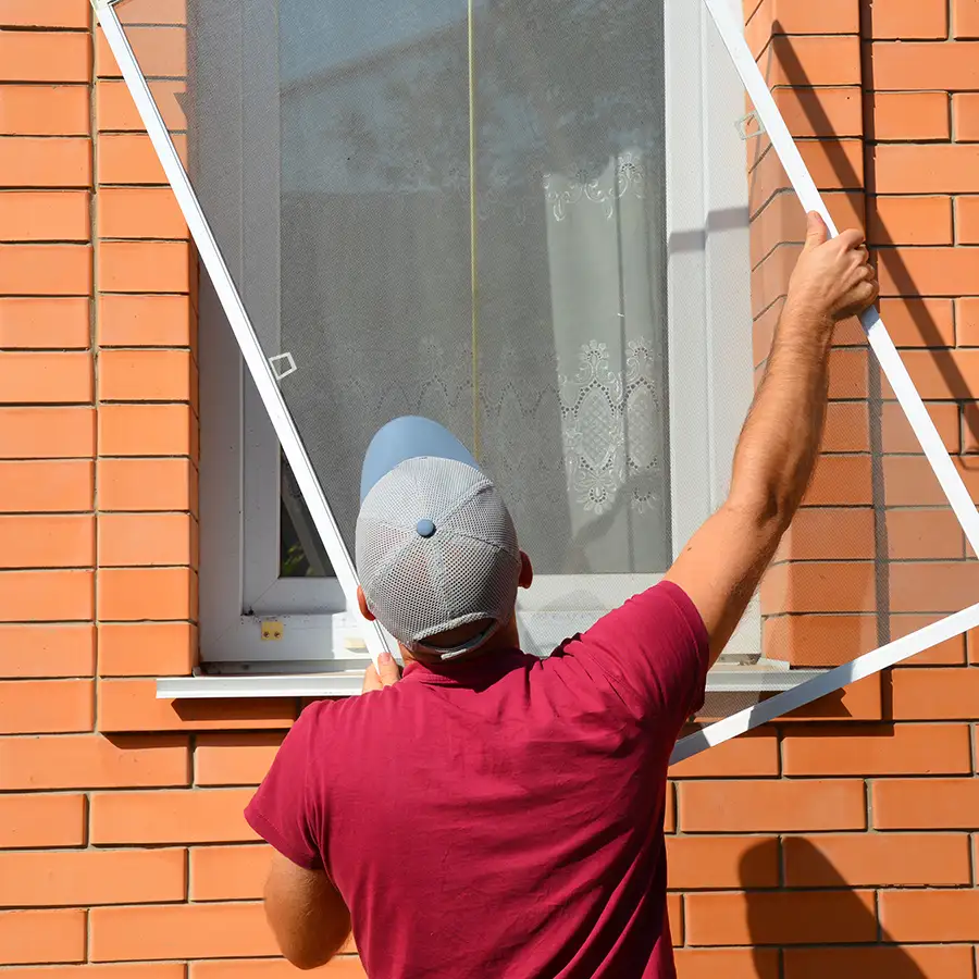 Technician installing a new window screen