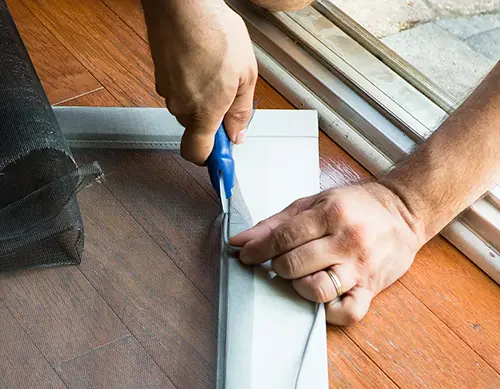 Person fitting a new screen to a frame in Vancouver, WA