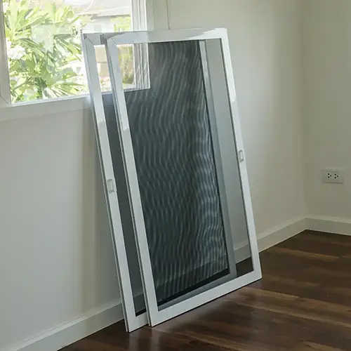 Two new customized screens leaning against the wall in house a house next to a window